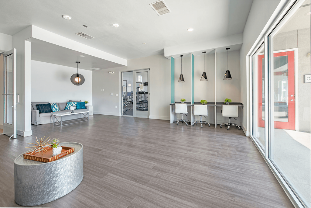 a resident clubhouse with gray flooring and white walls  at Collective on Riverside, Austin